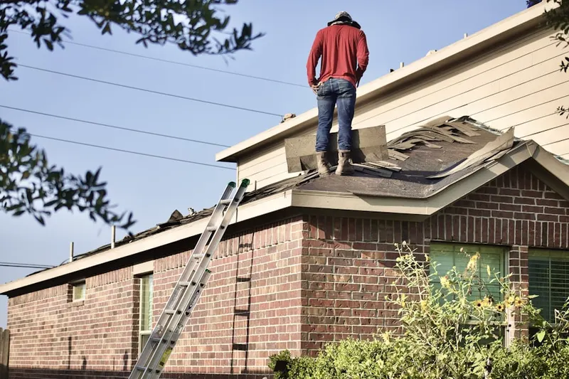 Professional roofer working on a residential roof in Prince Crossing
